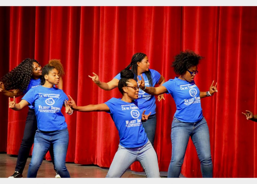 The Divine 9 is a group of sororities and fraternities who attend  the Black Heritage Celebration annually. Seen above, one of the sororities from the Divine 9 are performing in the auditorium. 