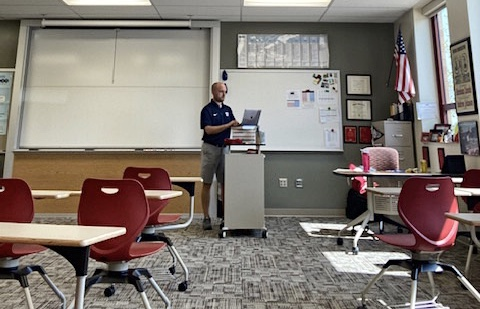 During office hours on Sept. 9, Matthew Stahl finishes up work towards the end of the school day at his podium in his empty classroom.