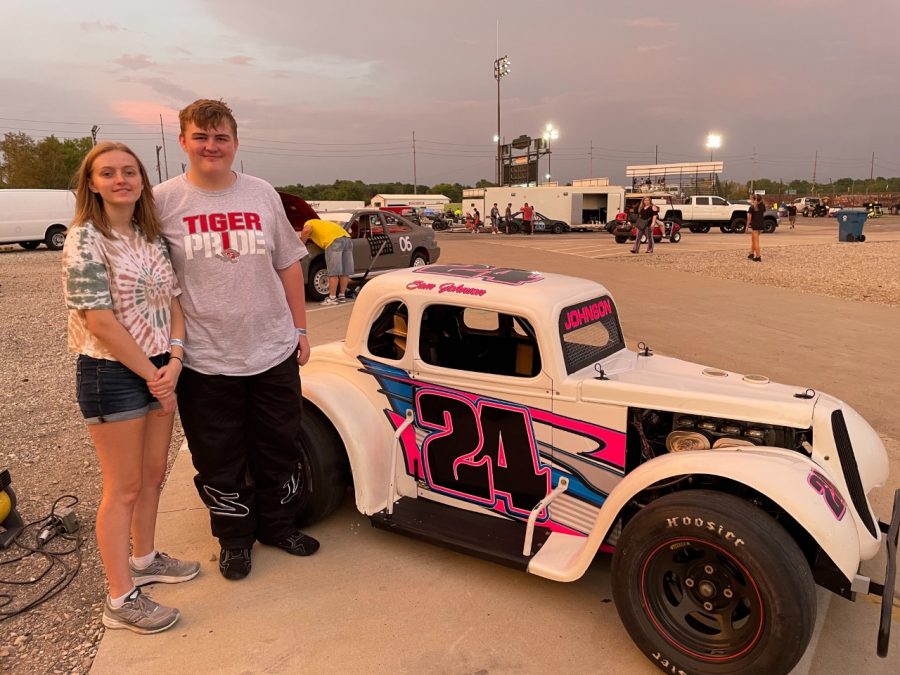 Sophomore Sam Johnson and his sister, senior Natalie Johnson, stand in front of Sams Legend race car. Sam Johnson is the second youngest driver in his age group (ages 14 to 50.)