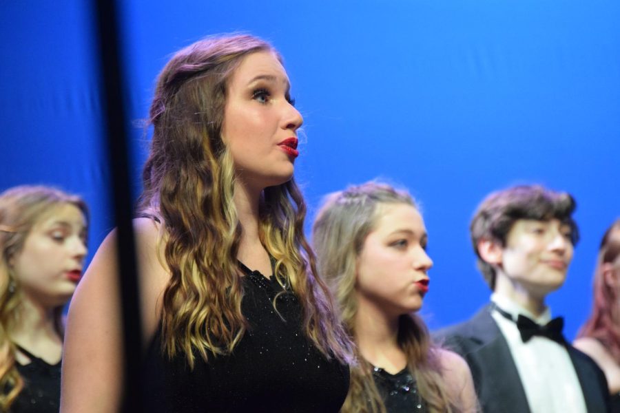 Junior Senna Maher,  sophomore Hannah Decaudin, junior Gracie Phlipot and sophomore Daniel Hobart sing “J’entends Le Moulin”, as a part of Electrum’s set. The spring concert was on Saturday, May 14.