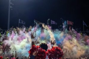 Students throw colored powder into the air at the homecoming football game on September 24, 2021. 