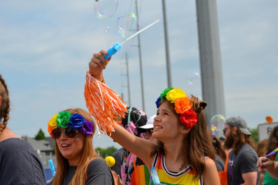 Bubbles are blown through the wind by a young girl participating in Indy’s pride parade. “What I had in mind [for Pride] was a lot of music, colors, dancing and just celebrating,” Puccinelli said. “I was right!”