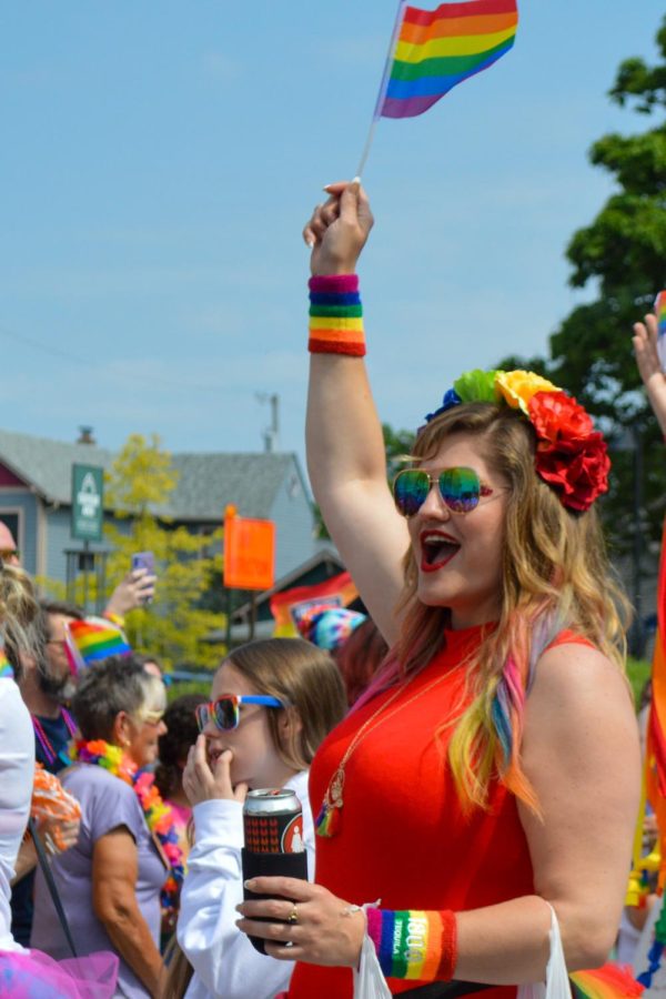 Parade participant triumphantly salutes their pride flag. “I really appreciate the people in the LGBTQ+ community who are not afraid to be themselves authentically,” Goldman said.