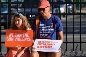 A mother and daughter sit at gun control protest sponsored by Moms Demand Action in Fishers, Indiana on June 3, 2022.