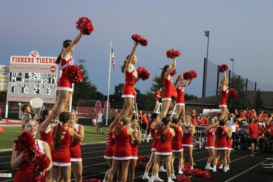 The Fishers cheer team holds stunts as they cheer along with the student section, wrapping up their ‘Baby Shark’ chant. ”In between the leaders, our energy is very awesome I feel like we are all very pumped up and happy to be there,” senior spirit leader Ava Pasalich said.