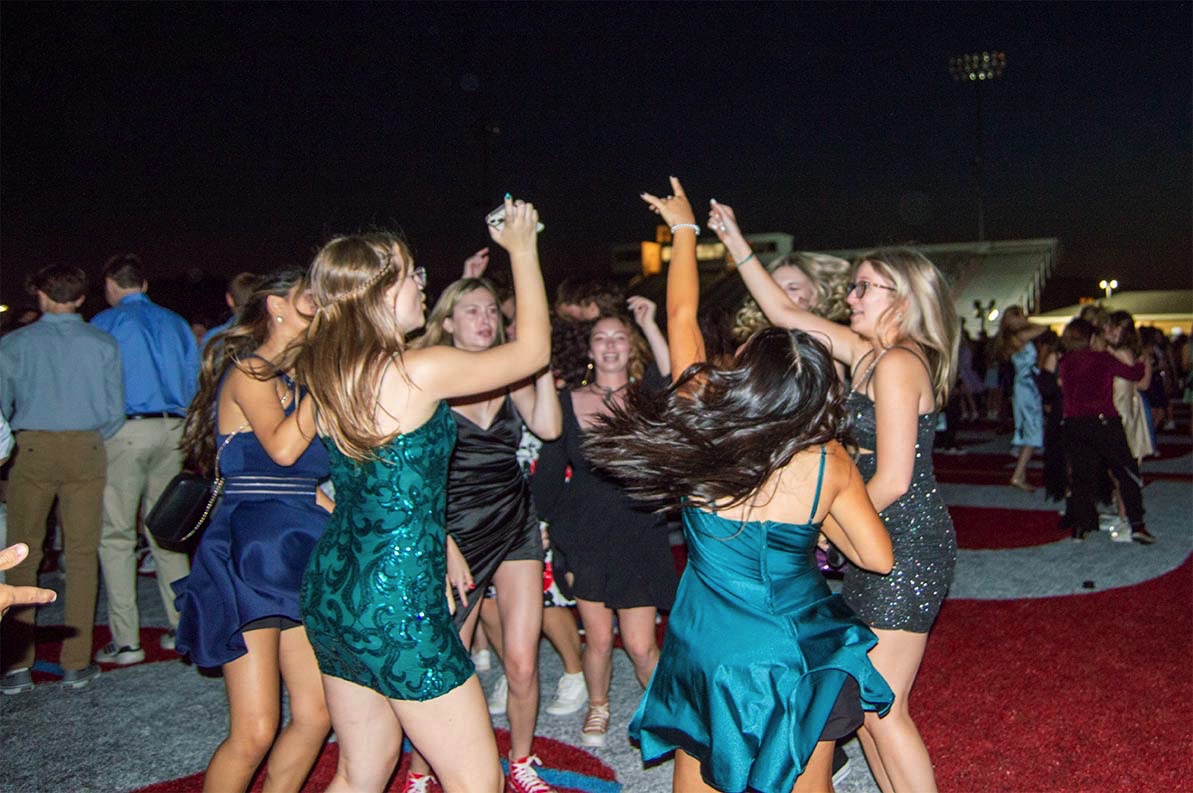 Students in a circle, located across from the DJ, dance together. The homecoming dance took place on Saturday, Sept. 17.  