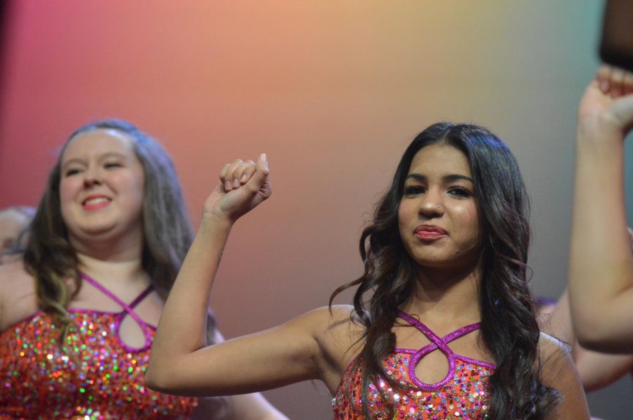 Sophomore Jenna Shearer and junior Gia Sethi hold up their right fist as a part of their performance for ‘Halo’ and ‘Walking on Sunshine’. The piece is arranged by Ed Lojeski. The fall concert took place on Sept. 27.