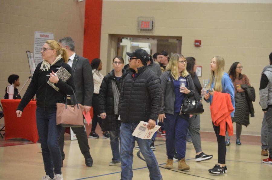 Parents enter the auxiliary gym to browse tables showcasing the clubs and athletic teams the school offers. “The [families] are all super sweet,” said sophomore Sharanya Srivastava. “Hearing that theyve heard about our club from their kids is super cool, and knowing that people are talking about us.” Eighth-grade parent night took place Feb. 1.