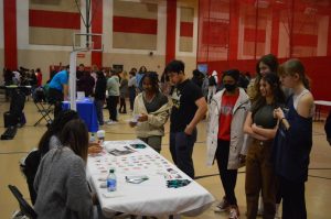 A group of fishers students discuss The Marriage & Family Health Clinic at the career fair on March 22, 2022.