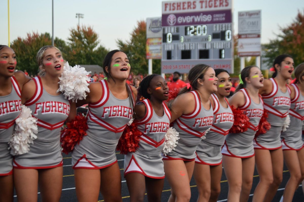 Fishers’ Cheer squad join together in a line and perform several chants to support the athletes before the game. “At the games there’s always a ton of spirit,” sophomore Eli Reisinger said. “But the homecoming game felt like a whole new world of spirit.” The Homecoming football game was on Sept. 22.