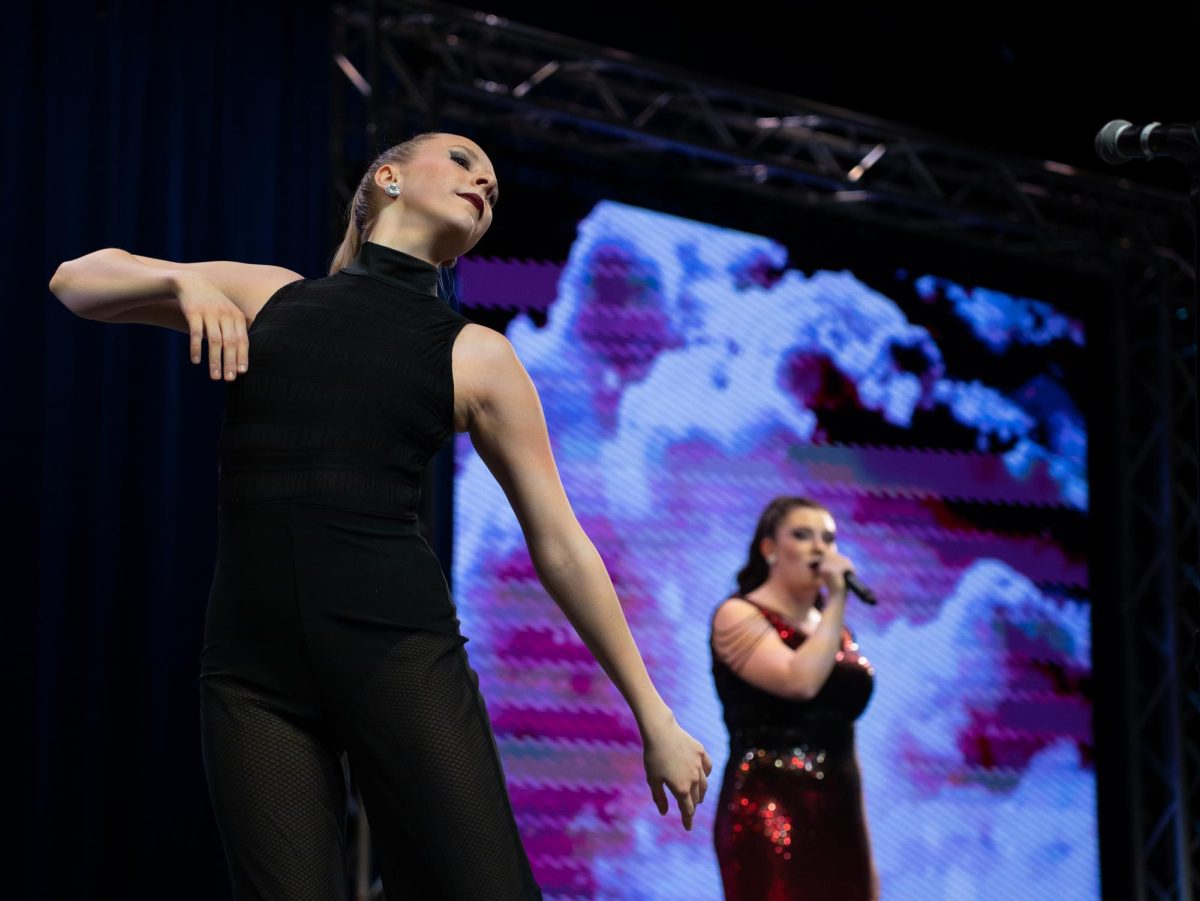 Junior Marissa Surette dances during Delaney Kearn’s solo in Fishers Sound’s “The Kiss of the Femme Fatale” set. Parent Preview Night took place on Feb 1, 2024. 