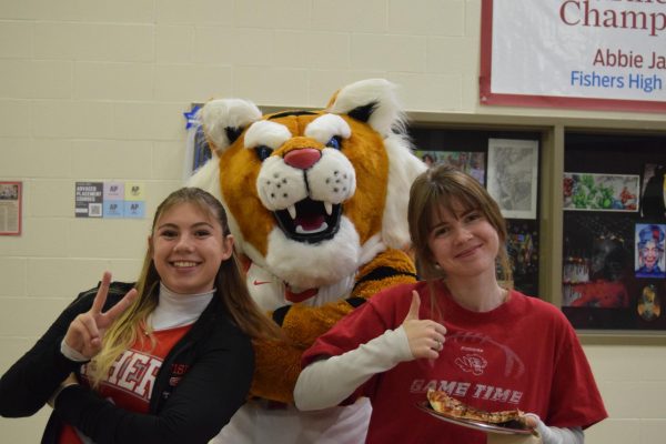 Seniors Madison Eberle and Jenna Talbot pose with Rumble at the Tiger Madness pre-party. “We brought the spirit,” Eberle said. Tiger Madness took place on Nov. 20.