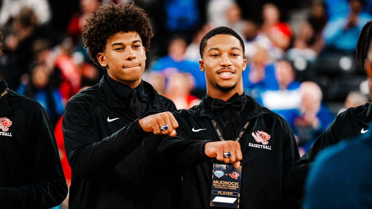 Seniors Justin Kirby (left) and Jon Anthony Hall (right) pose as they receive their state championship rings on Friday Dec. 20 at the Fishers Event Center. “It is our goal to go back-to-back this year, and I think it was great to have the same type of feel of a state game in the middle of the season,” Hall said. 