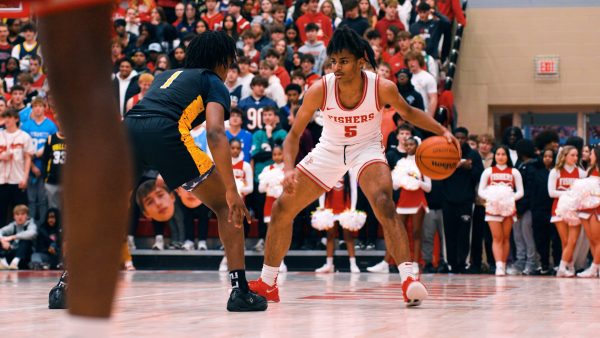 Sophomore Jason Gardener Jr. dribbles past a defender in a basketball game against the Avon Orioles on Jan. 24. The Tigers won 69-45. 