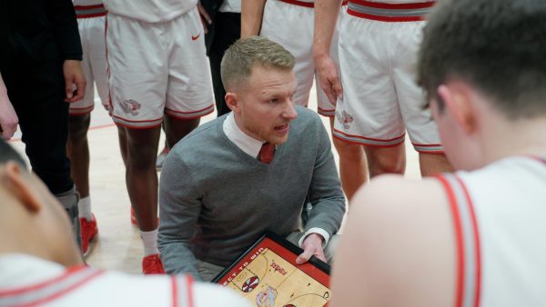 Head coach Garret Winegar directs his team during a timeout in a basketball game against Carmel High School on Feb. 1. The Tigers won 80-39.