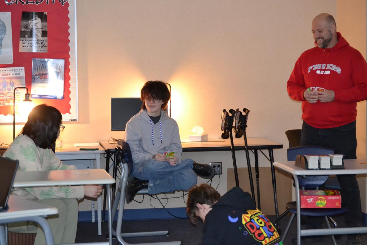 Junior August Johnson, freshman Will Hoffman, junior Alex Minnick and credit recovery teacher Mr. Wyngarden playing Apples to Apples at a Pin It Together meeting in A107 on Wednesday February 26.