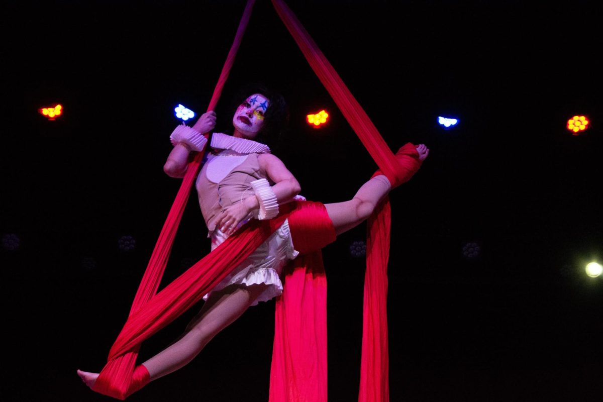 At the talent show fundraiser for the Riley Children’s Hospital, sophomore Kaden Lee poses on aerial silks midair at the FHS talent show on March 12. 