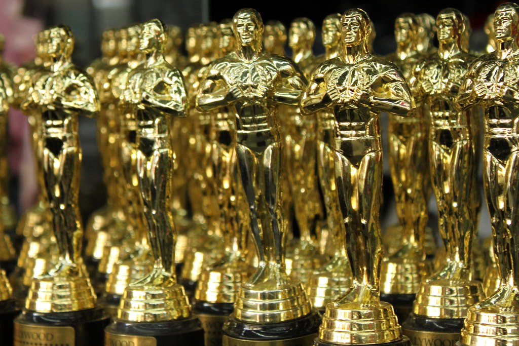 Photo showing several rows of trophies from the Academic Awards, more commonly known as the Oscars. Photo courtesy of creative commons.