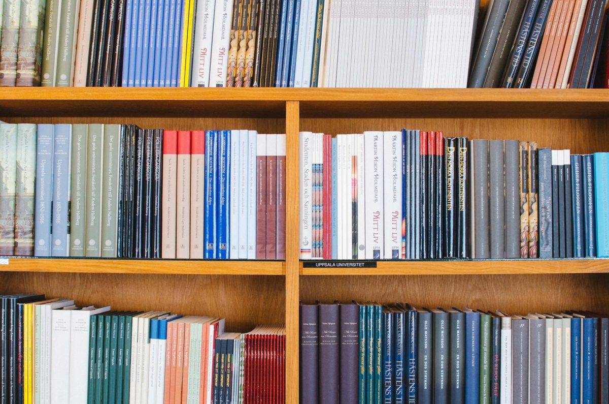 Books sit on a bookshelf.