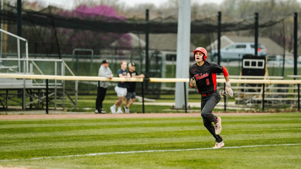 Senior Deagan Repp runs to home plate and scores the first run against the Noblesville Millers on April 18. The Tigers won 2-1.