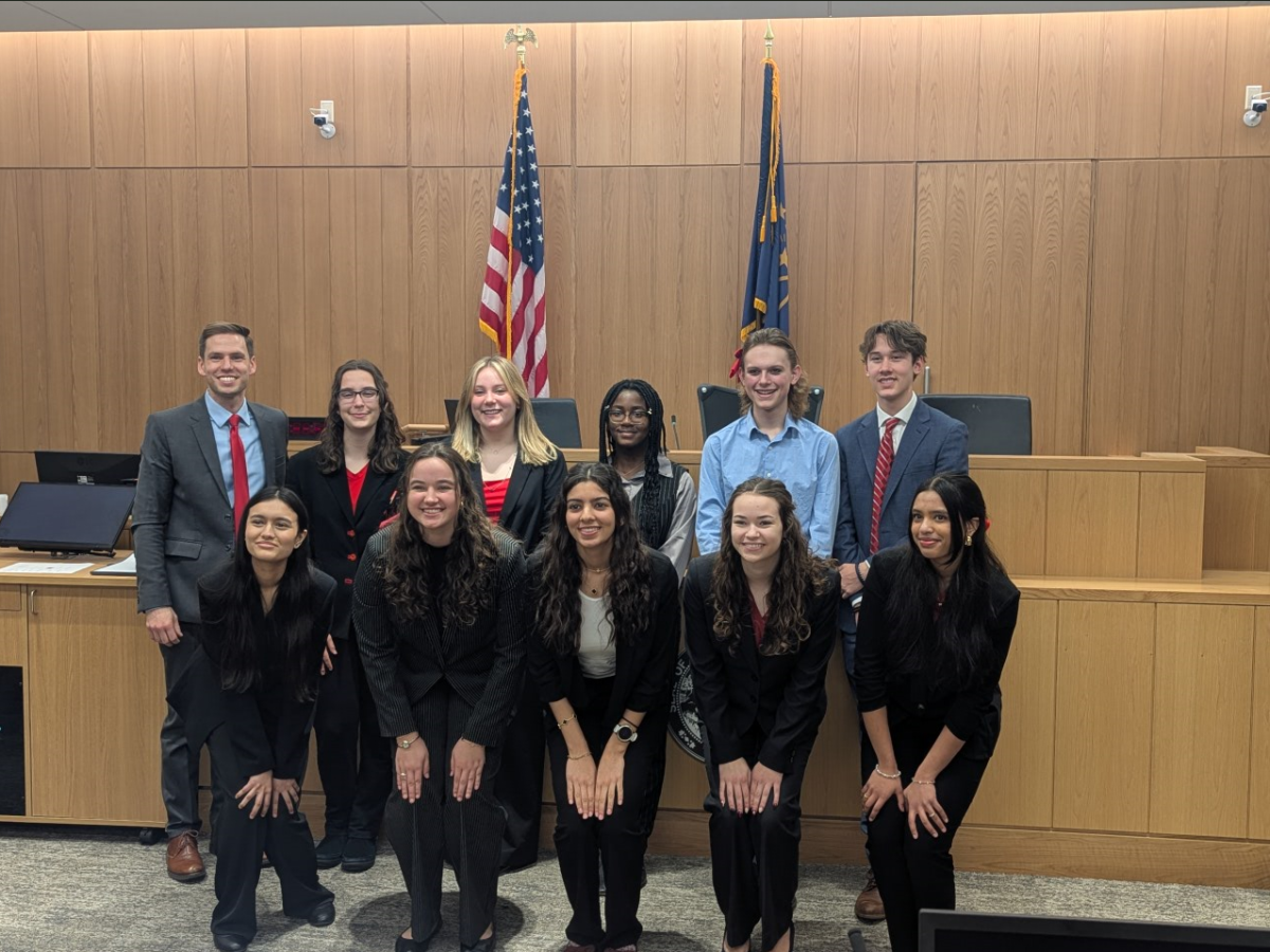 The FHS varsity Mock Trial team posing for a photo in front of a court room on March 9