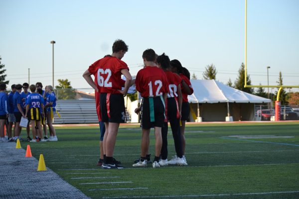 The Unified Flag Football team huddles up before taking the field on Sept. 11 for the Mudsock match against HSE. Fishers won 78-32.