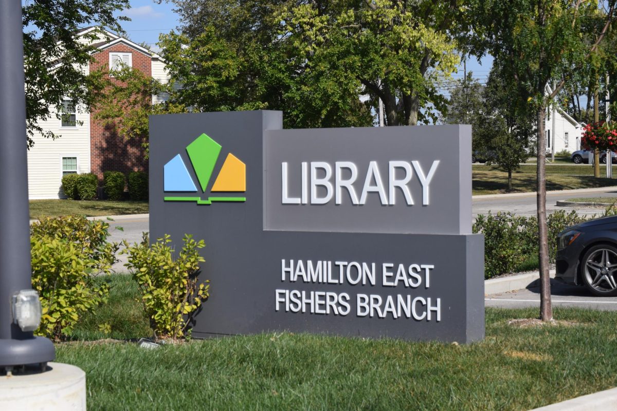 A sign that reads “LIBRARY, HAMILTON EAST PUBLIC BRANCH” is shown with green foliage surrounding. This picture is of HEPL’s own sign that is located just outside the library along Municipal Drive. 