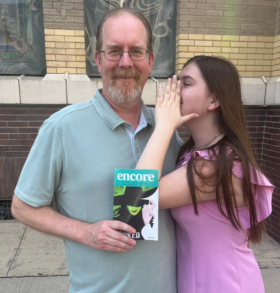 Junior Piper Sosnowski whispers a secret to her dad at the Old National Centre in Indianapolis on June 22, recreating the Wicked Broadway poster. Photo used with permission of Piper Sosnowski.