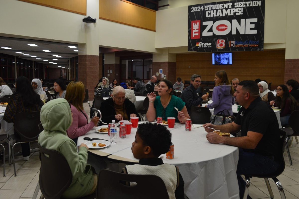 ENL Ambassadors Club hosted a Thanksgiving dinner party for families and friends in the cafeteria at Fishers High School on Nov. 20. One of the families was photographed while eating and chatting with each other. 