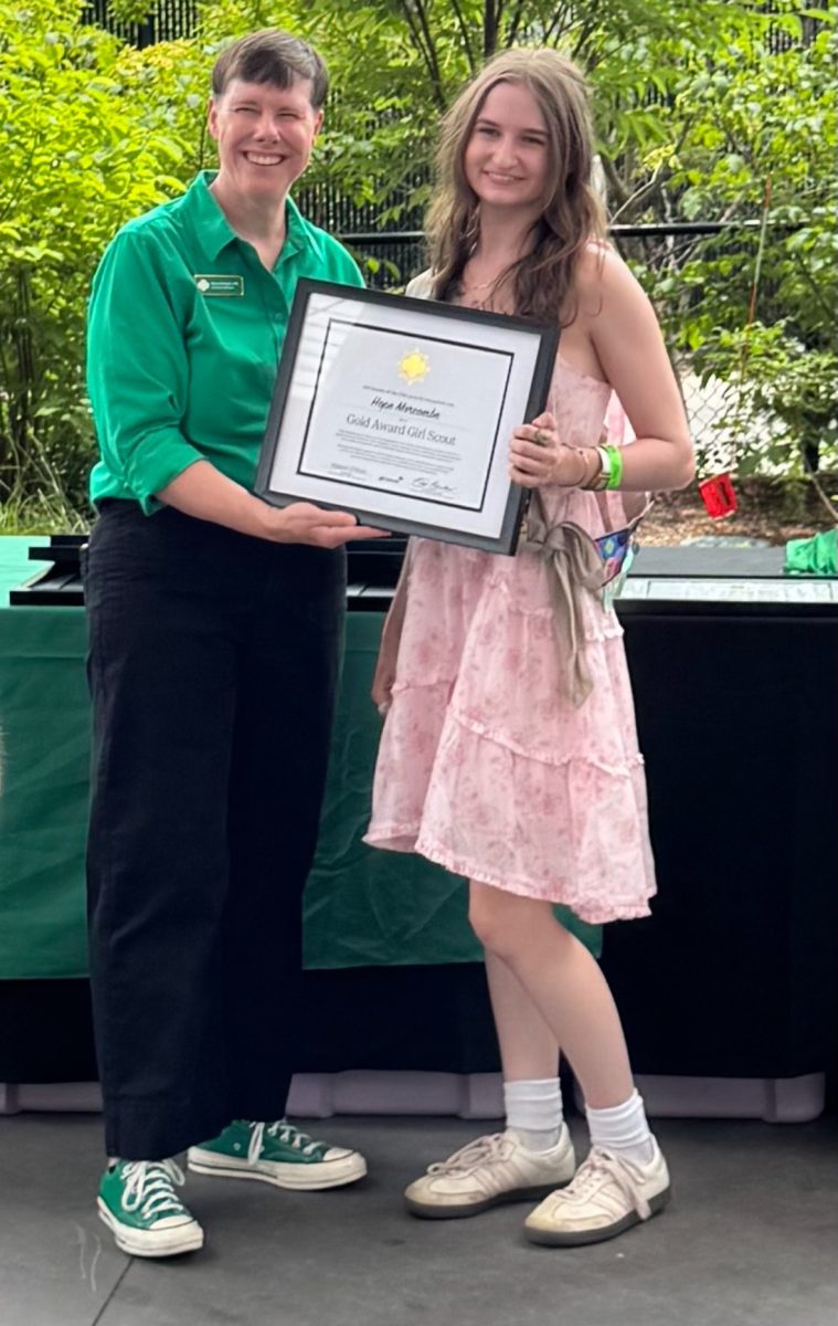 Senior Hope Morcombe poses with her Girl Scout Gold Award at the Indianapolis Zoo on June 29, 2025, after earning the organization’s highest honor. Photo courtesy of Jordan Morcombe. 