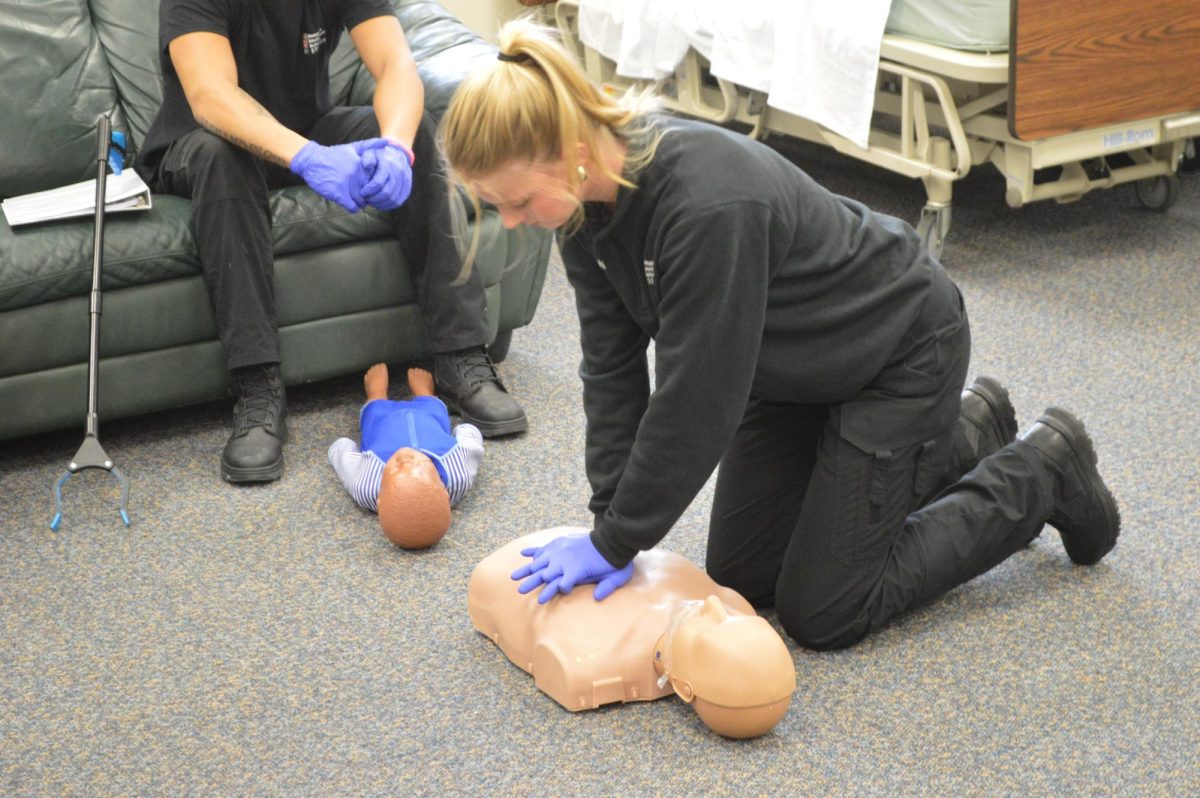Natalie Vinton performs CPR at her EMT program. EMT’s do not need a college degree, and need a different kind of certification. Photo by Elijah Ayugi.  