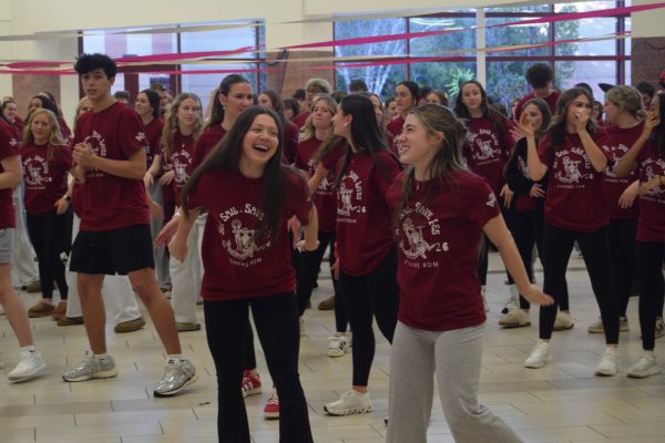 Junior Mollie VanVoorhis and junior McKenzie Vogler smile at each other while dancing for Riley Dance Marathon in the FHS CCA on Feb. 27. Both of their arms fly backwards in their shared dance. “I came to the dance marathon with my two friends because it’s fun to be around people who care about the same things as you do,” junior Lucille McMahan said. 