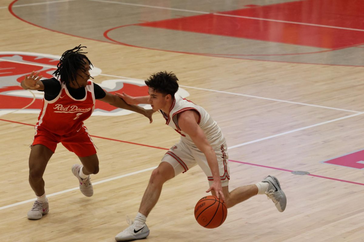 Junior Cooper Zachary dribbles the ball on Jan. 8 at FHS against Pike High School. The final score was 76-67. Photo by Milo Martinez. 