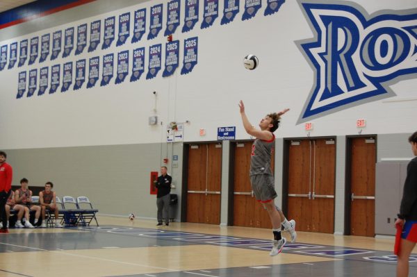 FHS varsity team captain, senior Jacob Thomas, is winding up a shot in a volleyball scrimmage against HSE at HSE high school on Mar. 18. This was during the first of three set rounds. Photo taken by PJ Collins.