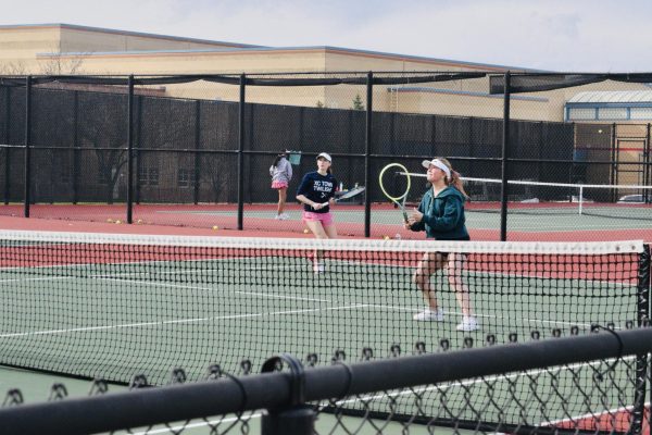 Junior Isabella Brown gazes up while she prepares to hit a tennis ball during practice on March 24, 2026. Photo used with permission of Emma Seland.