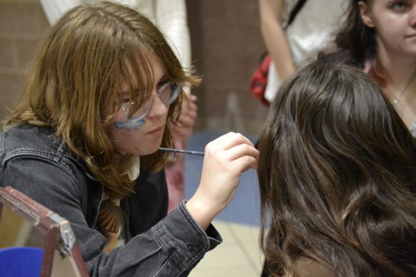 Senior Corina Davidhizar paints a child’s face with the FHS art club as part of the HSE district art show on March 21. The HSE art show highlighted hundreds of pieces of artwork from students across the district.