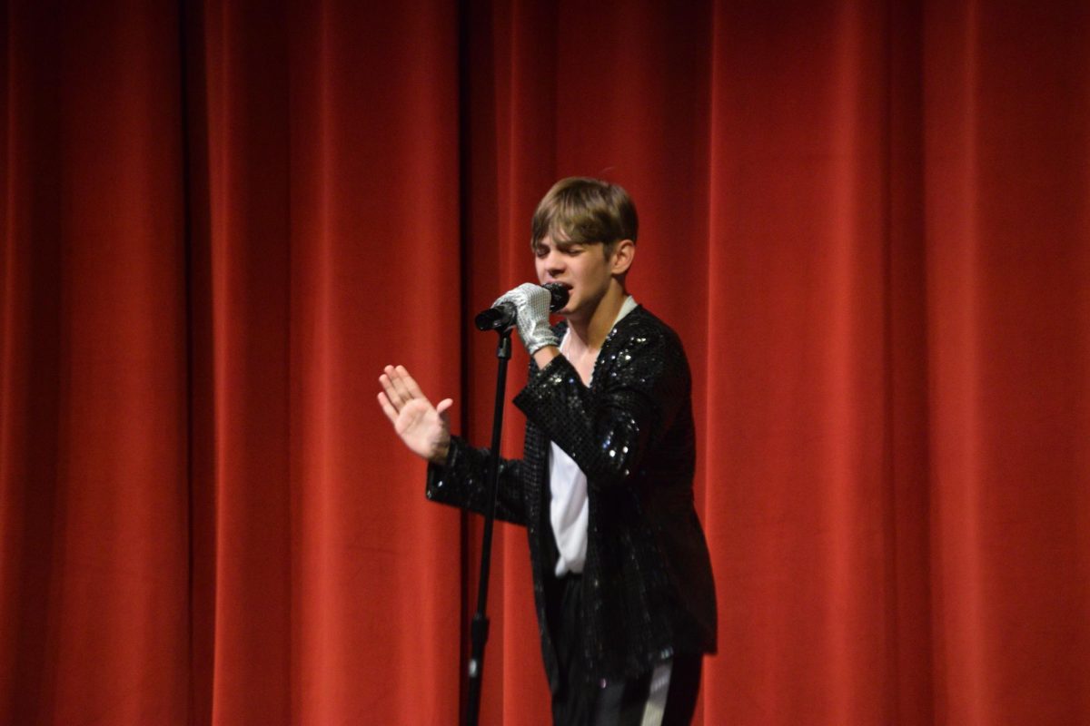 Freshman Alexander Surra imitates Micheal Jackson during his “American Classic’ performance in the FHS auditorium on April 17. Surra performed the song “Billie Jean” by Michael Jackson. Photo by Jerry Schmidt. 