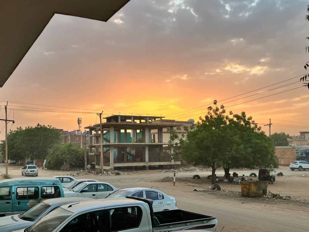 The sun sets behind a building under construction in Khartoum, framing a moment of daily life and urban development nearly a year before the outbreak of major conflict on May 31, 2022. Photo courtesy of Osama Eisa. 