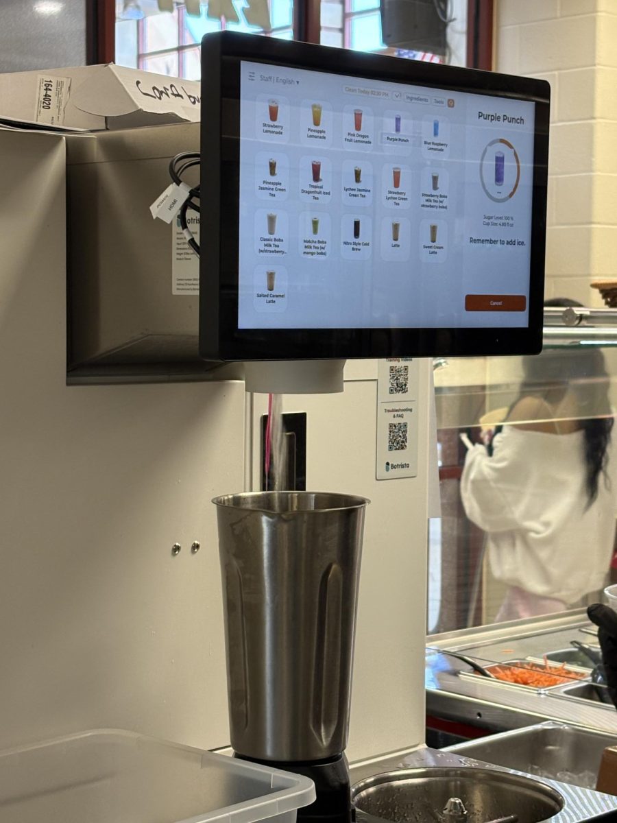 The new Botrista machine is an entirely programmed drink mixer. Any drink on the menu can be created with the push of a button. Café co-manager Katie Greenwood crafts a drink on May 7. Photo by Ella Kirkmeyer. 