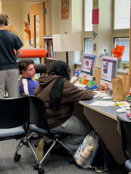 Senior Keaton Haselby and junior Sondos Mertami of the Tiger Tracks yearbook staff works during the spring supplement’s deadline night. Photo courtesy of Lexie Black.