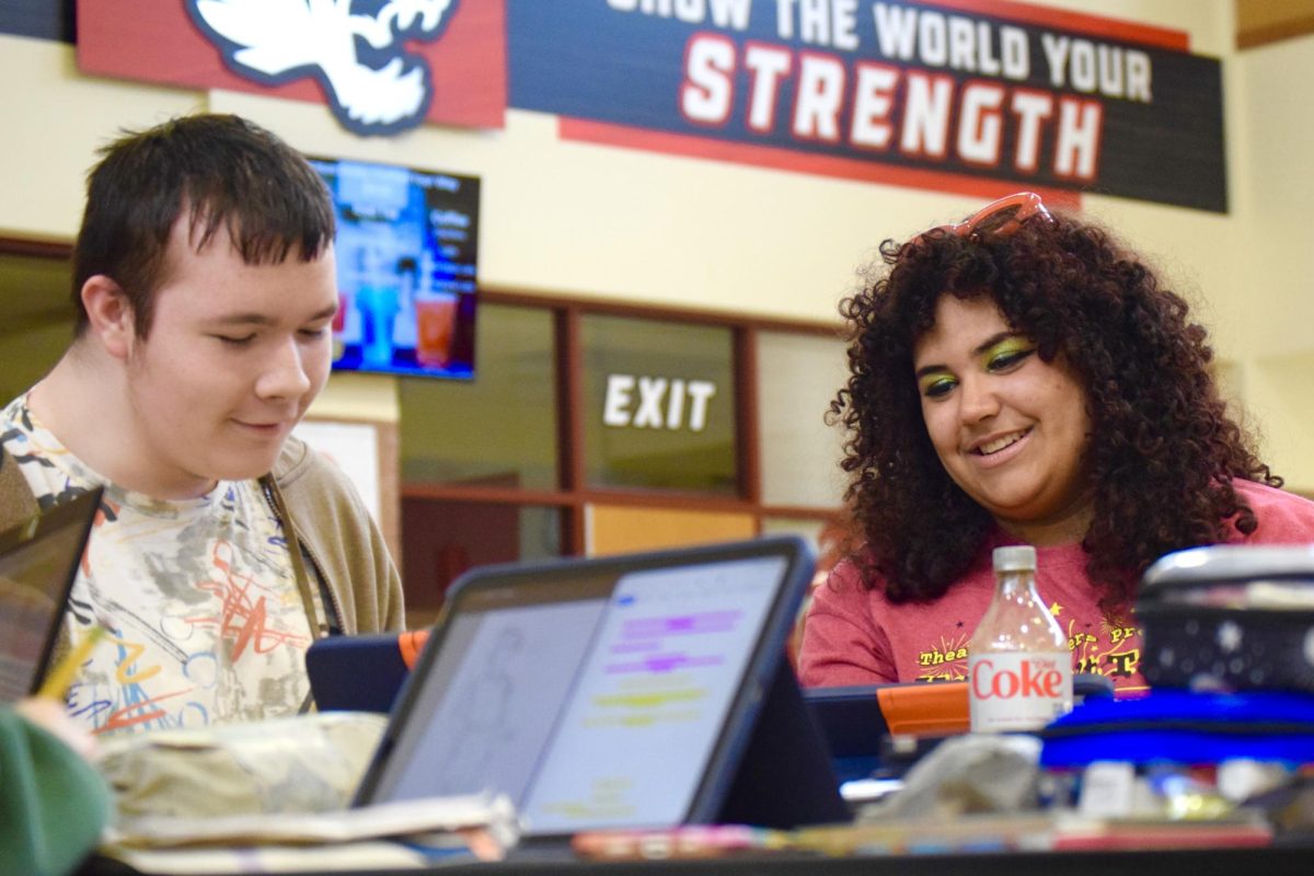 Freshmen Gunner Seely and Sophomore Phoebe Jean-Pierre review Seely’s storyboarding in the CCA on Friday, May 8. Jean-Pierre smiles while looking at Seely’s drawings. Photo by Jerry Schmidt.  